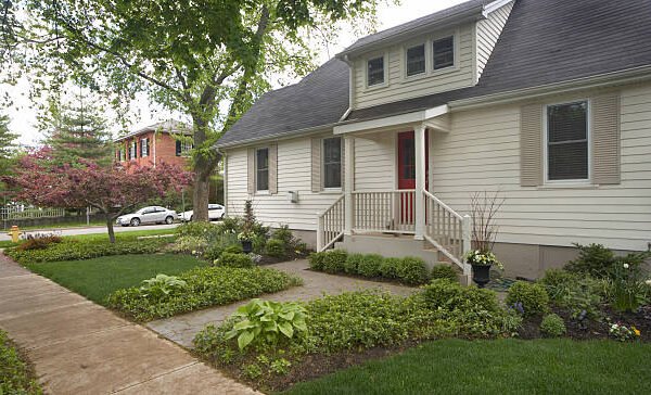 A contemporary home with a stone exterior and a driveway, emphasizing its attractive curb appeal.