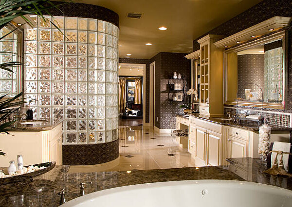 A spacious bathroom featuring a large tub and an expansive mirror, showcasing a modern remodeling design.